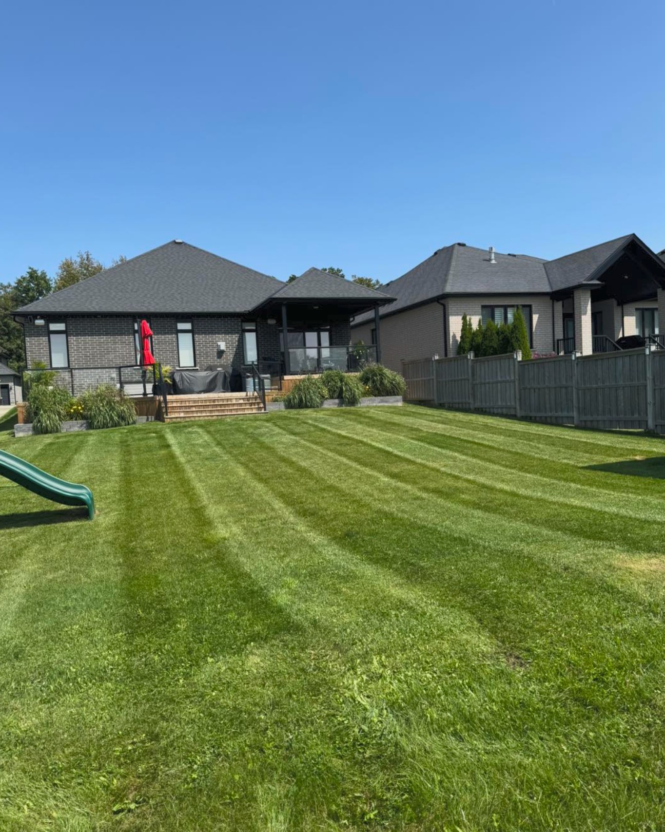 Striped residential lawn maintained by Brothers Landscaping in London Ontario