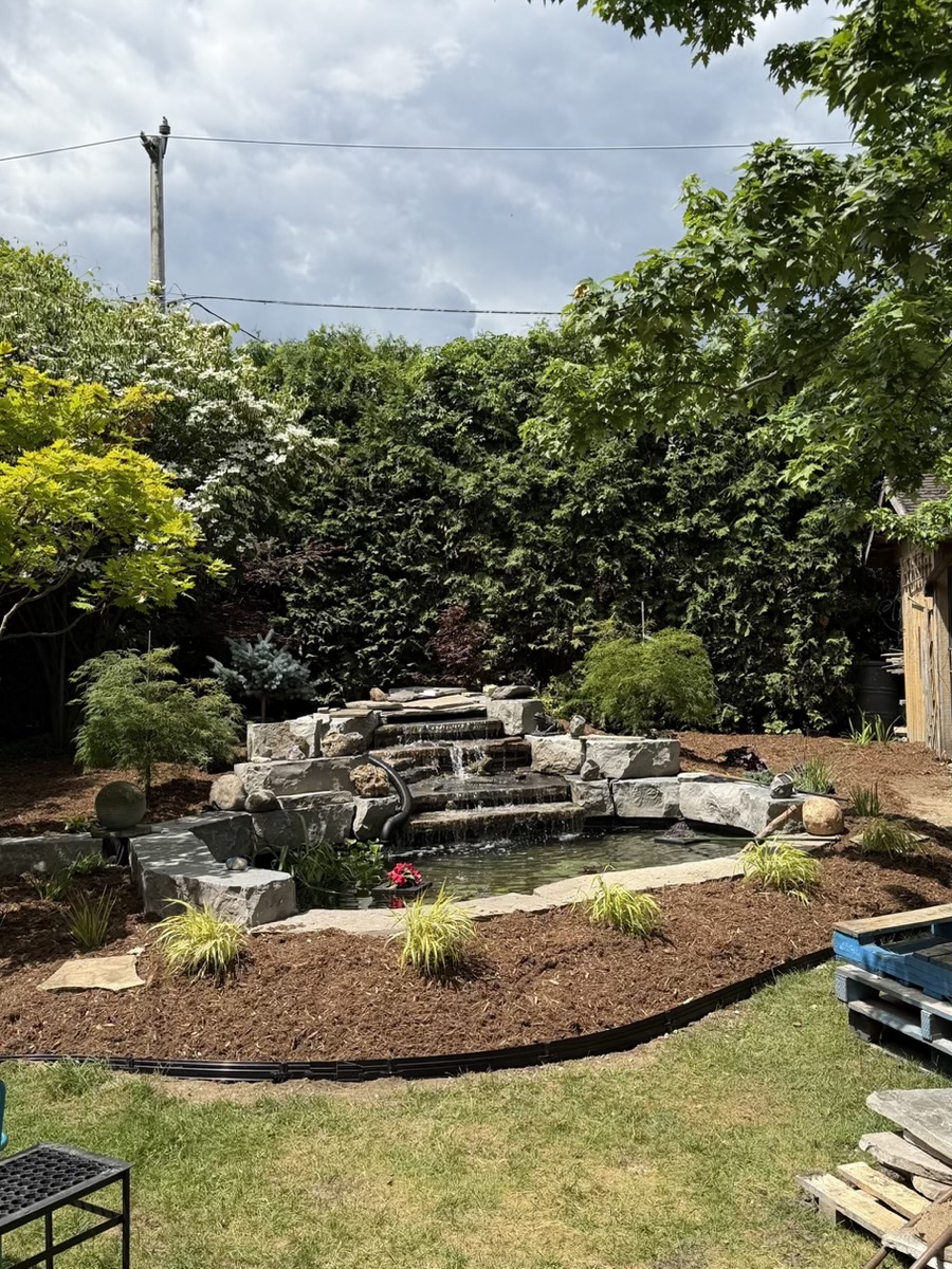 Completed pond and waterfall landscape project by Brothers Landscaping
