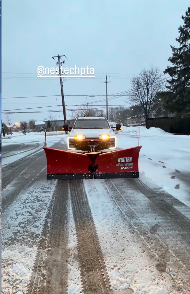 Plow truck clearing a snow-covered road