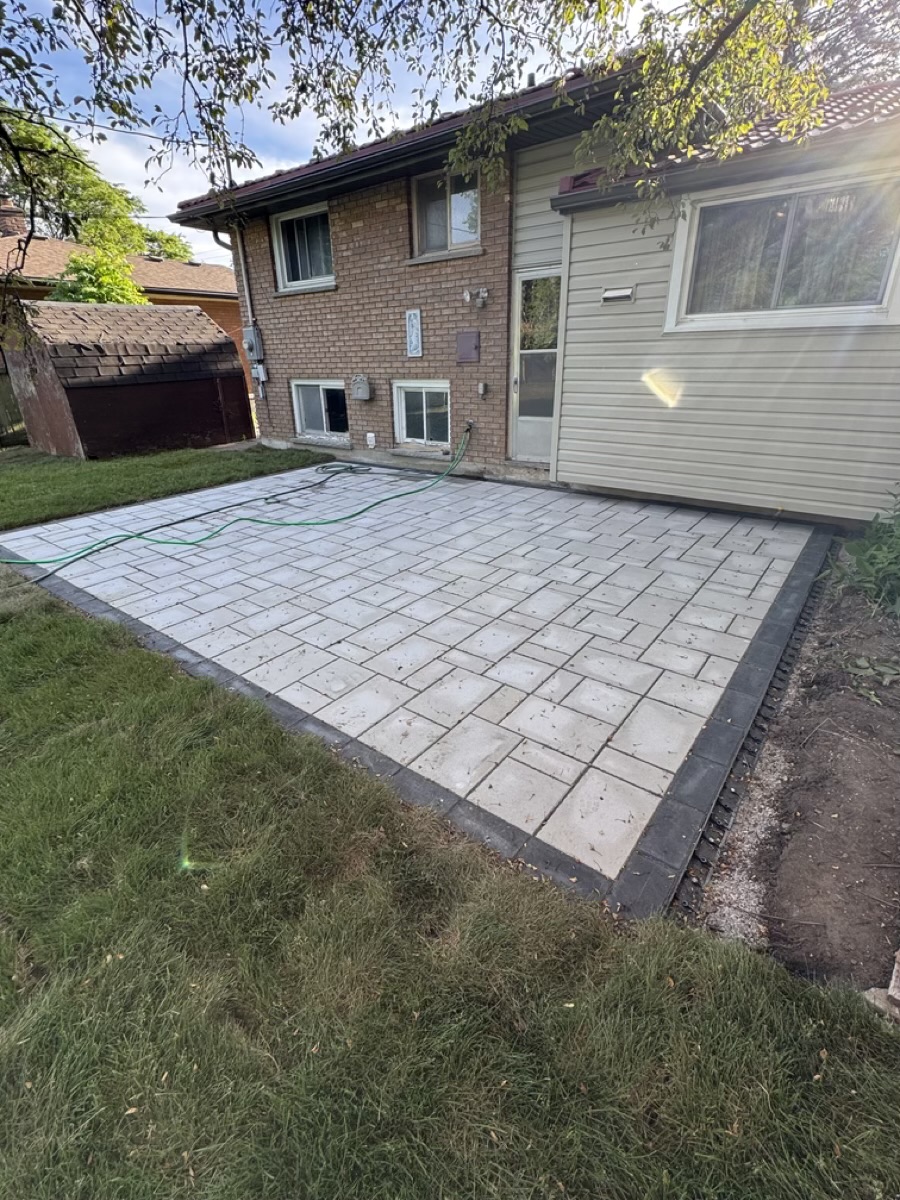 Finished paver edge beside a newly landscaped lawn